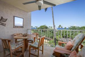 a room with a table and chairs and a balcony at Puako Beach 309 Oceanview 3BR Condo in Waikoloa