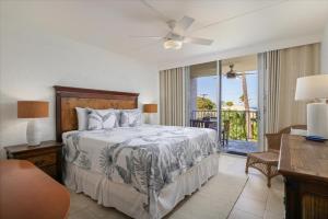 a bedroom with a bed and a balcony at Puako Beach 309 Oceanview 3BR Condo in Waikoloa +30 photos