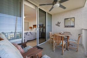 a living room with a table and a bedroom at Puako Beach 309 Oceanview 3BR Condo in Waikoloa