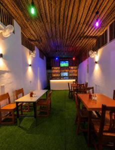 a restaurant with tables and chairs and a ceiling at Nanaa Hotel in Nungwi