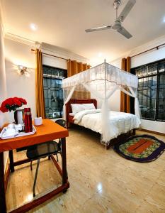 a bedroom with a bed with a canopy at Nanaa Hotel in Nungwi