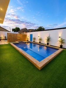 a swimming pool in the backyard of a house at Nanaa Hotel in Nungwi