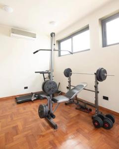 a gym with two treadmills and weights in a room at Wentworth - SKYSUITES in Accra
