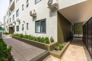 a building with plants on the side of it at Wentworth - SKYSUITES in Accra