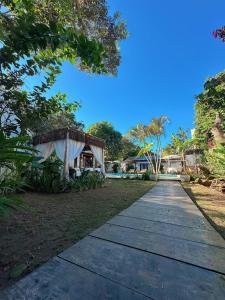 a walkway leading to a resort with a building at Casa Valldemossa in Búzios