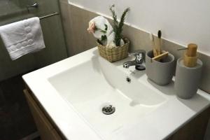 a bathroom sink with a basket on top of it at Casa Orígenes Hotel Boutique in Pamplona +48 photos