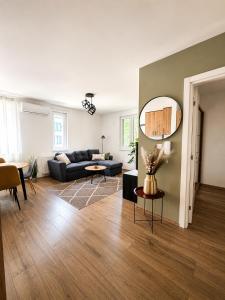 a living room with a couch and a mirror at Ilidža Park Apartments in Sarajevo