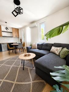 a living room with a couch and a table at Ilidža Park Apartments in Sarajevo