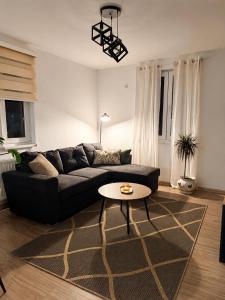 a living room with a couch and a table at Ilidža Park Apartments in Sarajevo