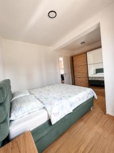 a bedroom with a large bed and a window at Ilidža Park Apartments in Sarajevo