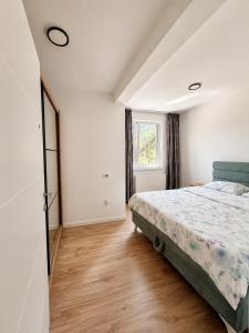 a bedroom with a bed and a window at Ilidža Park Apartments in Sarajevo +124 photos