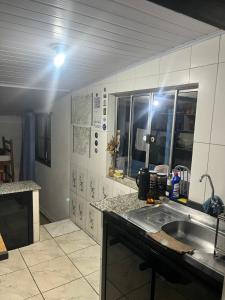a kitchen with a sink and a counter top at Abrigo e Camping Recanto das Arvores in Itamonte +74 photos