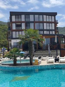 a hotel with a swimming pool in front of a building at Grand Lake View Apartment in Ohrid