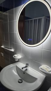 a bathroom with a white sink and a mirror at Marinello house in Oliveri
