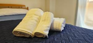 two rolled up towels sitting on top of a bed at Marinello house in Oliveri +4 photos