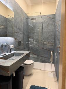 a bathroom with a sink and a shower at Catalano Suite Marina - Vista Mare in Palermo