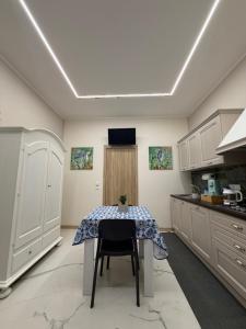 a kitchen with a table with a table cloth on it at Catalano Suite Marina - Vista Mare in Palermo +12 photos