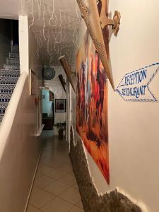a hallway with a painting on the wall at Riad Le Lieu in Tiznit