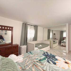 a bedroom with a bed and a large mirror at Spacious 2BR Apt - Kitchen - Laundry - WiFi in Yauco