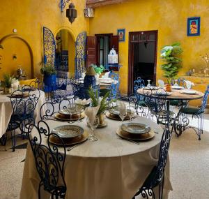 a dining room with tables and chairs in a building at Riad Le Lieu in Tiznit