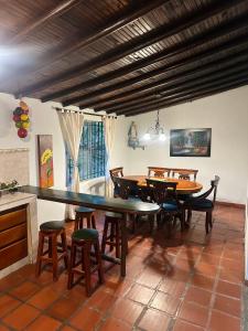 a dining room with a large table and chairs at Casa Solar in Guatapé