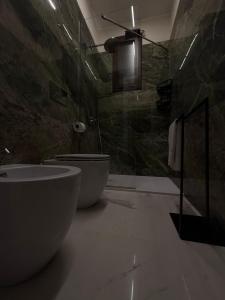a bathroom with a tub and a toilet and a shower at Catalano Suite Giada - Vista Mare in Palermo +19 photos
