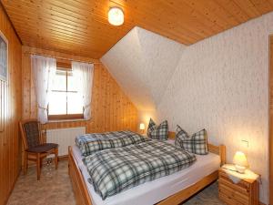 a bedroom with a bed in a wooden room at Glashof in Sankt Georgen im Schwarzwald