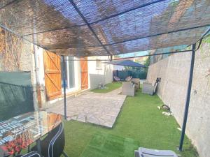 an outdoor patio with awning on a building at Villa Emeraude in Cagnes-sur-Mer +3 photos