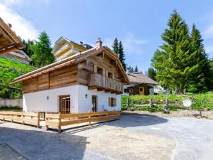 a house in the woods with a fence at Chalet Paul in Katschberghöhe