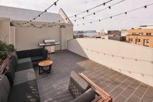 a balcony with a couch and a table on a building at Harbour Rocks by Ode Hotels in Sydney +33 photos