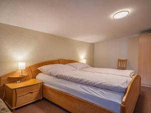 a bedroom with a large bed with a wooden frame at Das Bergnest Bergluft in Söll