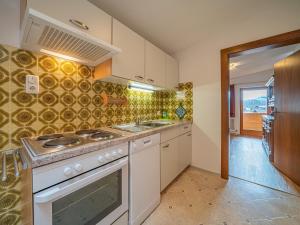 a kitchen with a stove and a sink at Das Bergnest Salvenblick in Söll +20 photos