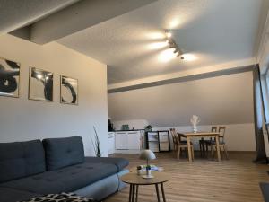 a living room with a couch and a table at Ferienwohnung Reichenbach in Bad Schussenried