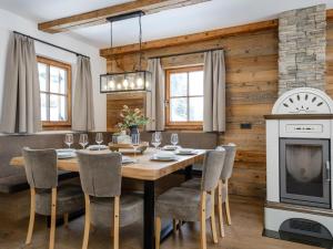 a dining room with a table and chairs and a fireplace at Chalet Cornelia in Gatschberg +21 photos