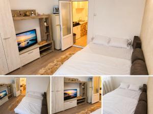 a room with two beds and a television in it at Garsonieră in Năvodari