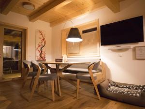 a dining room with a table and chairs at Chalet Gipfelduo in Ebene Reichenau