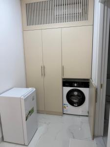 a kitchen with a washer and a washing machine at Alisa's apartments Ureki in Ureki