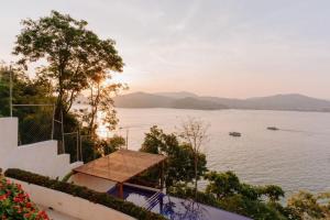 a view of a large body of water with a boat at Pacífica Grand Zihuatanejo in Zihuatanejo