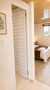 a sliding closet door in a bedroom with a bed at Brisa y Lienzo - Hostal Boutique in Puerto Colombia