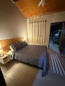 a bedroom with a large bed with a wooden ceiling at Pousada Caravelas in São Miguel do Gostoso +26 photos