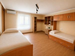 a bedroom with two beds and wooden cabinets and a window at Amazing view bungalow MA2 in Torrevieja