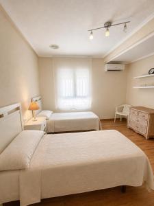 a bedroom with two beds and a window at Amazing view bungalow MA2 in Torrevieja