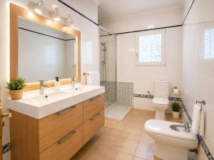 a bathroom with a sink and a toilet and a mirror at Amazing view bungalow MA2 in Torrevieja