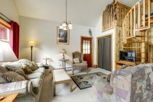 a living room with a couch and a tv at 'Marble Hideaway' Cabin w/ Mountain Views + Deck! in Marble