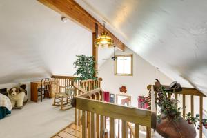 a large room with a staircase and a living room at 'Marble Hideaway' Cabin w/ Mountain Views + Deck! in Marble