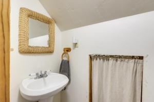 a bathroom with a sink and a mirror at 'Marble Hideaway' Cabin w/ Mountain Views + Deck! in Marble +23 photos