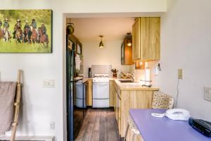 a kitchen with white appliances and a blue counter top at Colorful Cabin w/ Teepee, Fire Pits & Mtn Views! in Marble