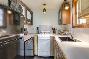 a kitchen with a stove and a sink at Colorful Cabin w/ Teepee, Fire Pits & Mtn Views! in Marble +18 photos