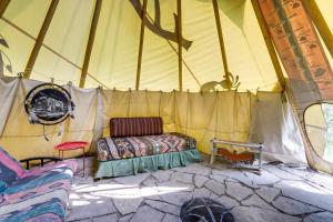 a tent with a bed in the middle of it at Colorful Cabin w/ Teepee, Fire Pits & Mtn Views! in Marble