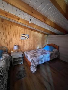 a bedroom with a bed and a nightstand in a attic at Cabaña en Rafael in Tomé
